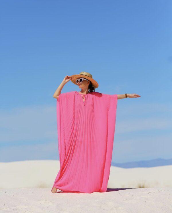 woman in pink caftan outdoors