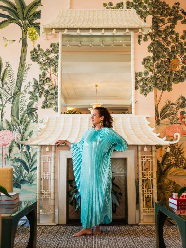 model wearing a teal pleated caftan